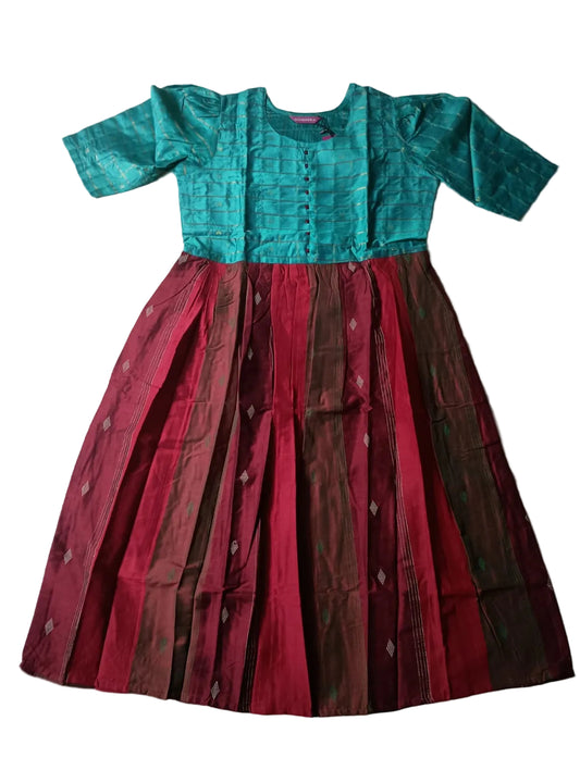Two-piece outfit with teal top and red skirt on a light gray floor.