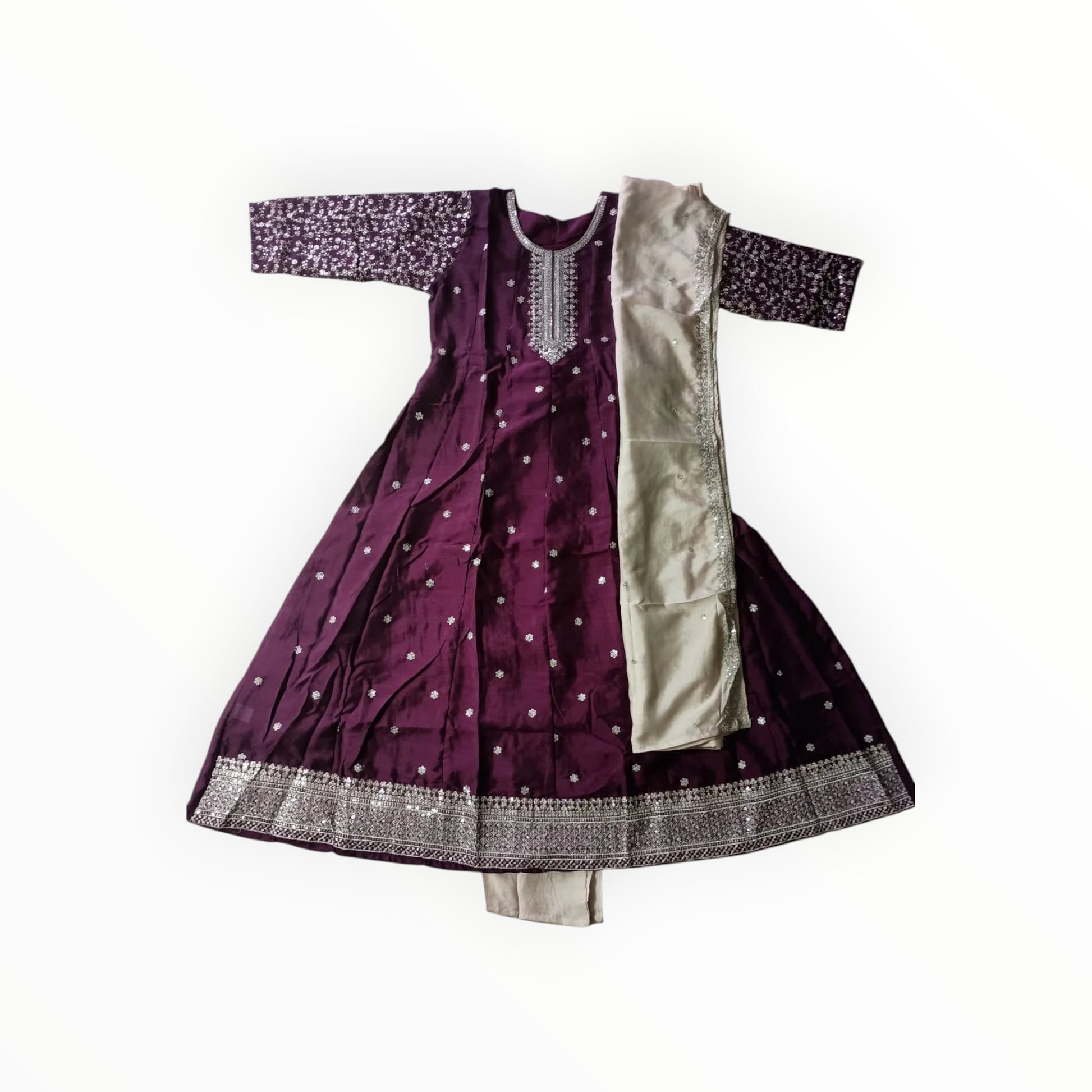 Purple traditional outfit with white patterns on a tiled floor
