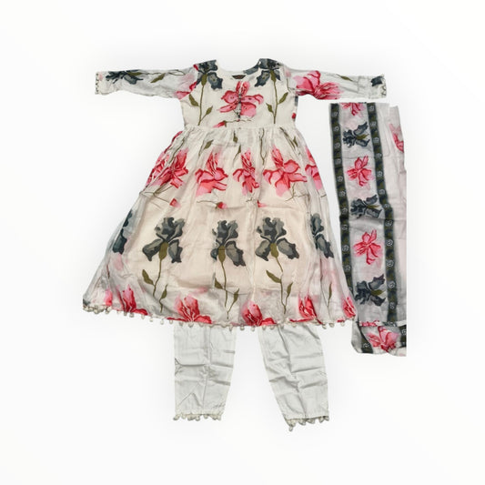 kidshe white 3-piece Anarkali suit with pink and grey floral print, pom-pom trim, and white pants.