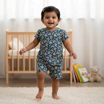 kidshe baby girl floral coord set featuring a dark green short-sleeve top and matching shorts in a nursery setting