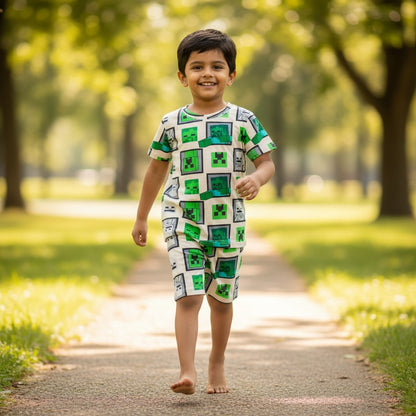 kidshe 3-4 year old boy wearing a green and white pixelated graphic print short sleeve coord set in a park