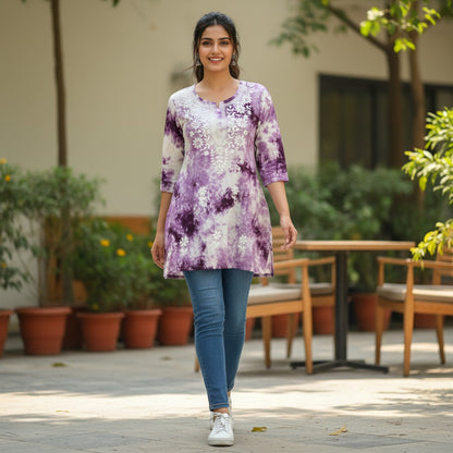 kidshe purple and white tie-dye short top with white floral embroidery on the yoke and 3/4 sleeves.