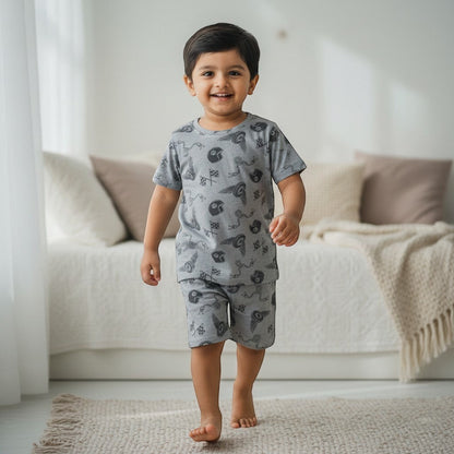 kidshe toddler boy wearing a grey short-sleeve t-shirt and shorts coord set with racing car and flag print